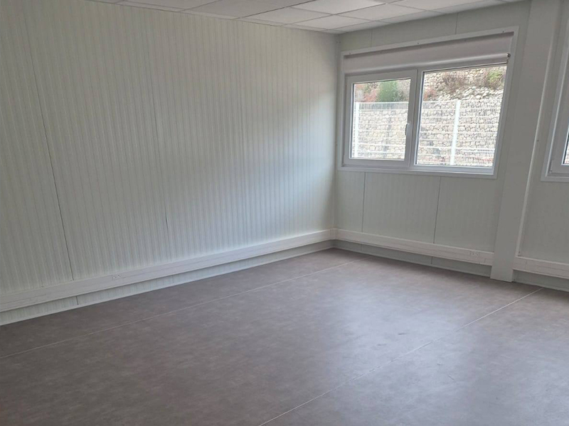 Installation d’une base vie et bureau de 120m² avec électricité, climatisation et faux-plafond.